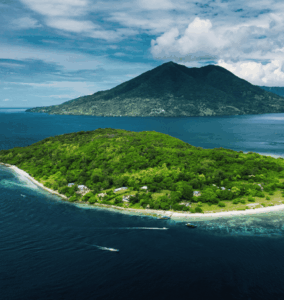 Lush green island surrounded by coral-rich waters in Indonesia’s Ring of Fire.
